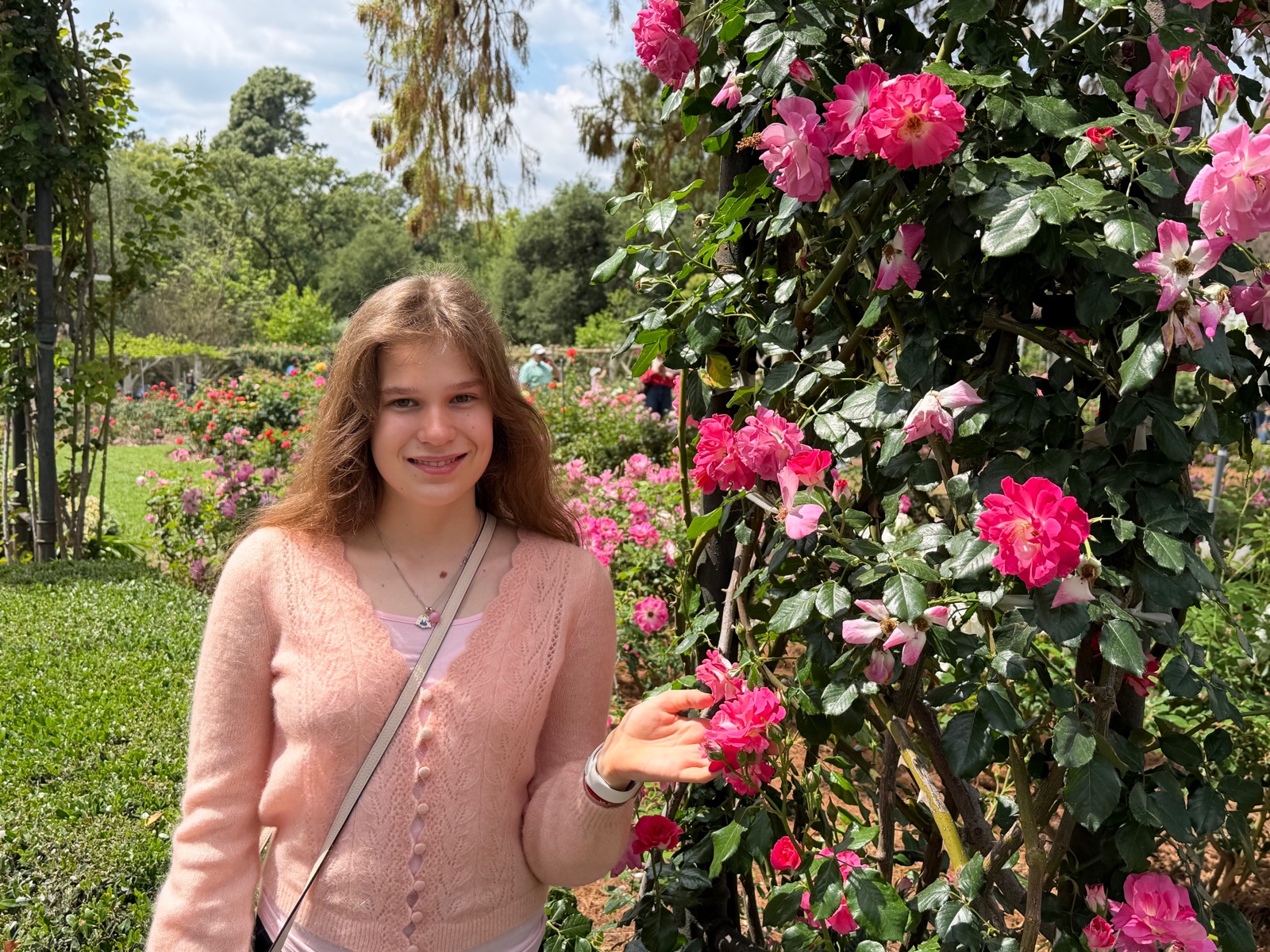 Varvara Trofimova smiling in a rose garden